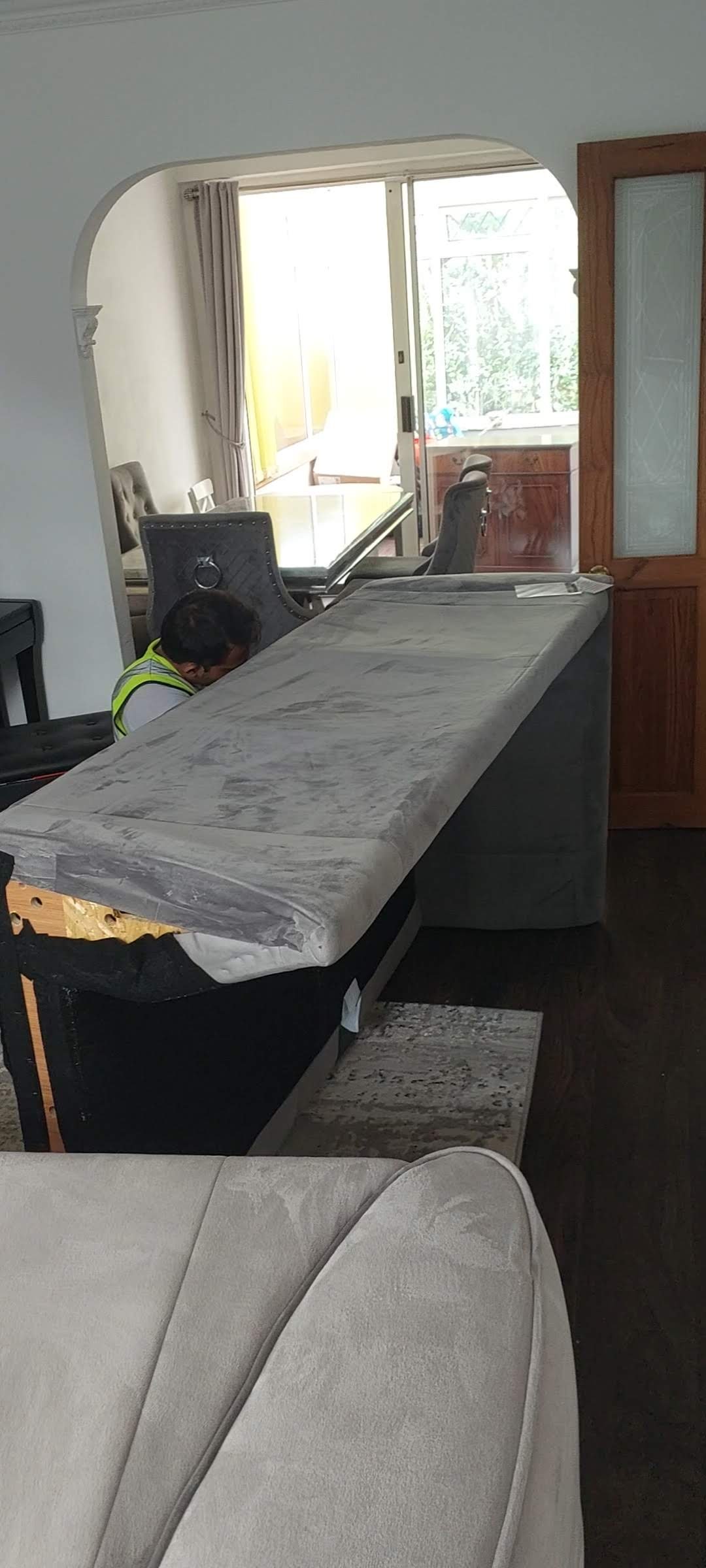 Furniture dismantling service removing sofa to pass doorway